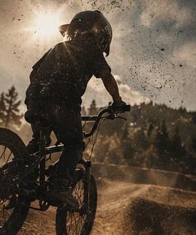 Kid on a BMX bike catching dirt in the sun
